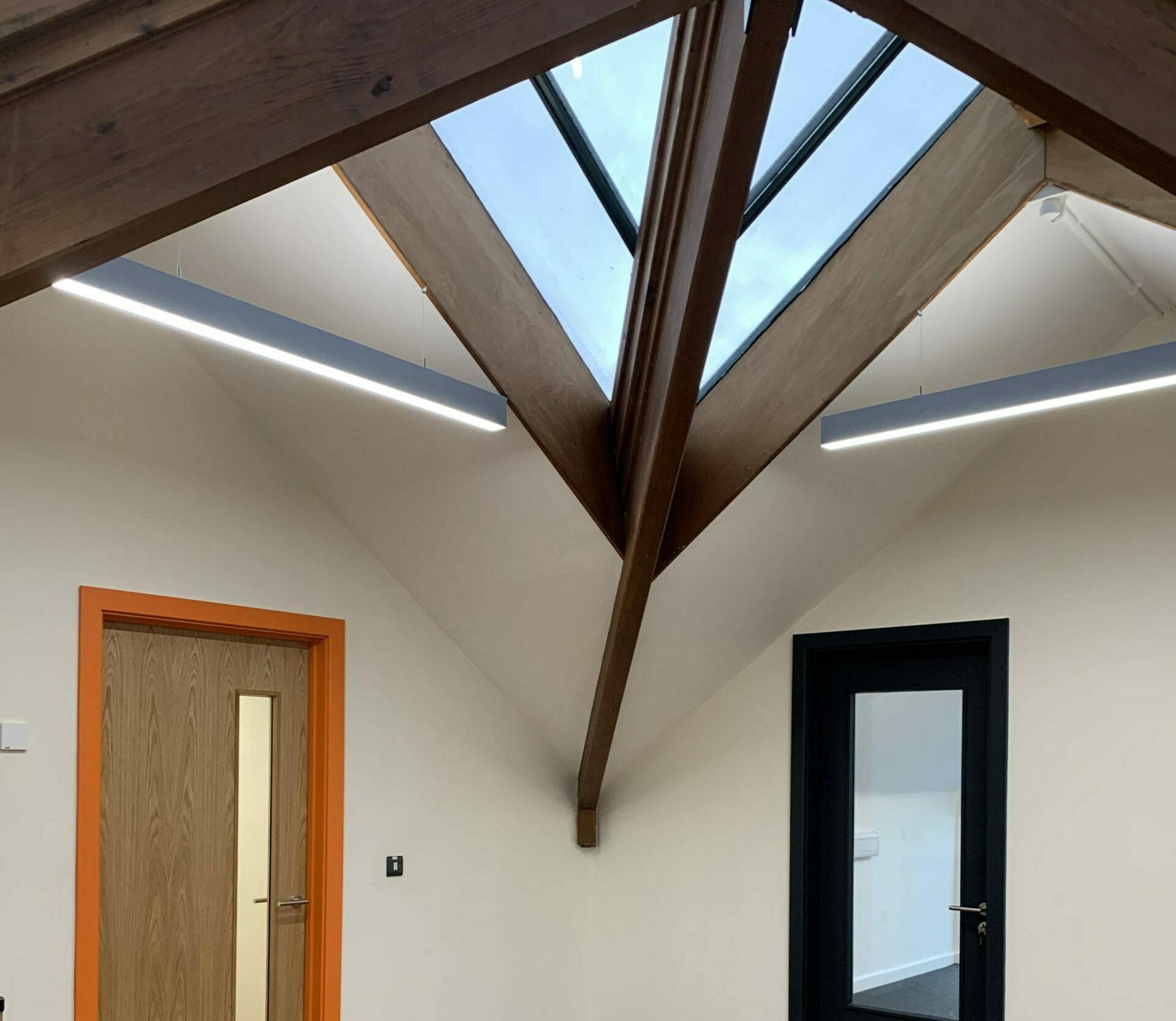 The interior of Glebe House surgery, showing beams and a skylight